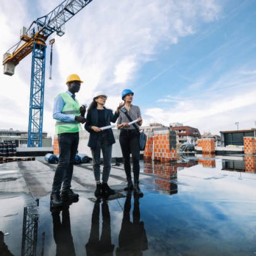 Architects and investors meeting at the construction site, on top of the residential building under construction.